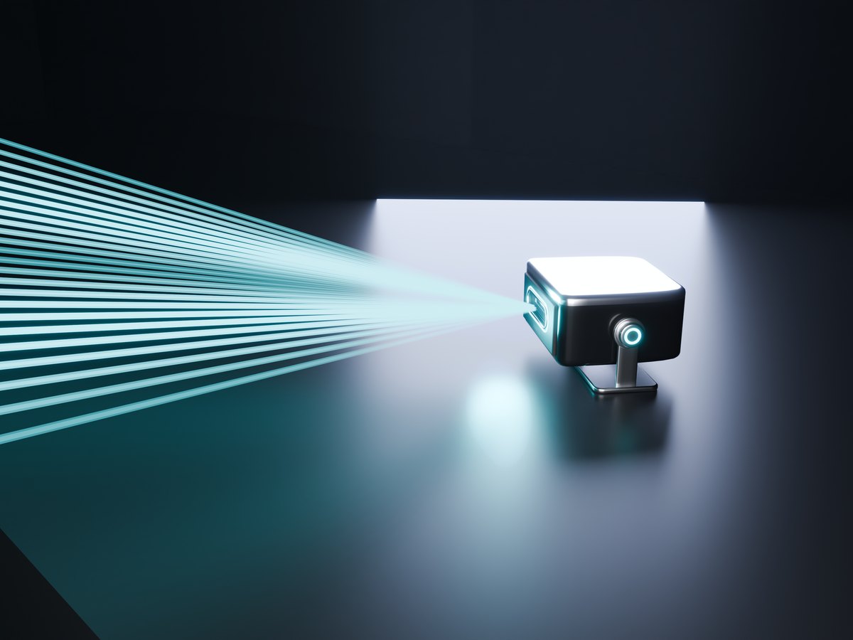 The Sync Laser in its bracket, a fan of cyan beams leaving its window
